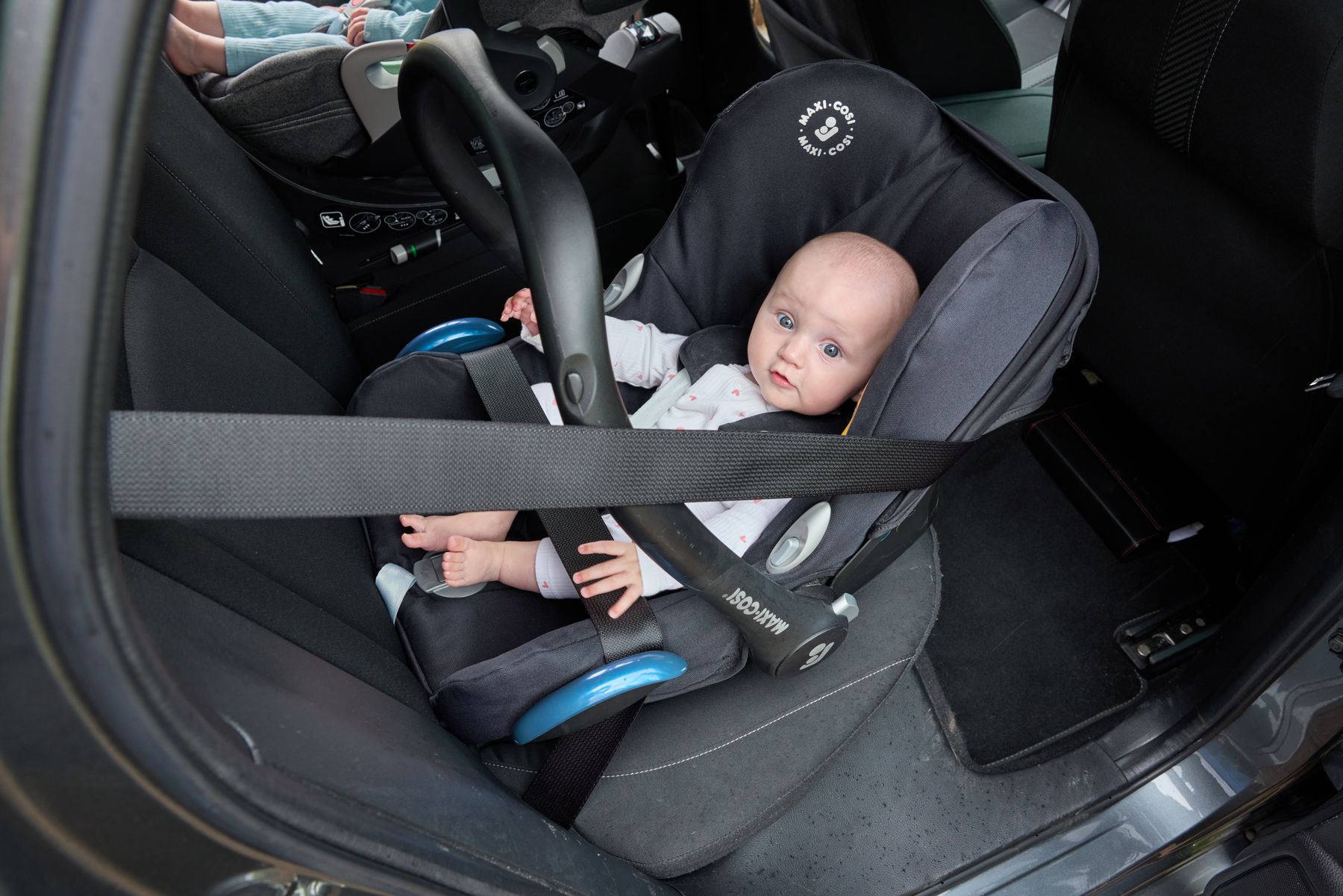 A baby in a rear-facing infant carrier